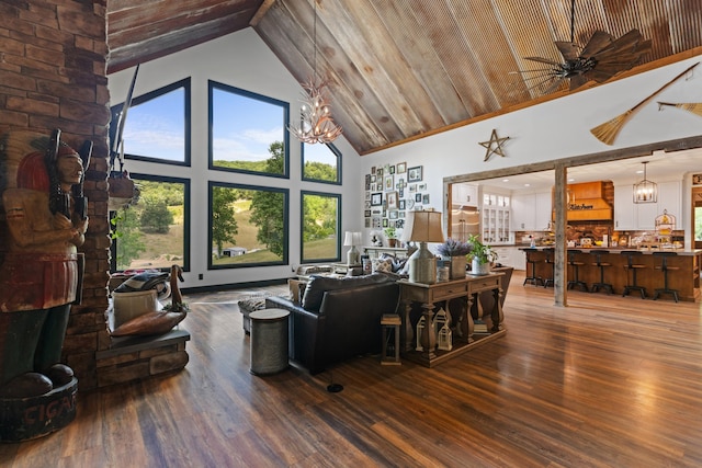 living room featuring hardwood / wood-style floors, ceiling fan with notable chandelier, high vaulted ceiling, and wooden ceiling