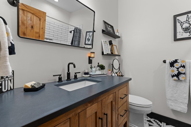 bathroom with vanity, toilet, and walk in shower