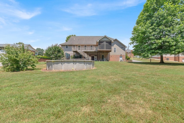 view of yard with stairs, an outdoor pool, and a wooden deck