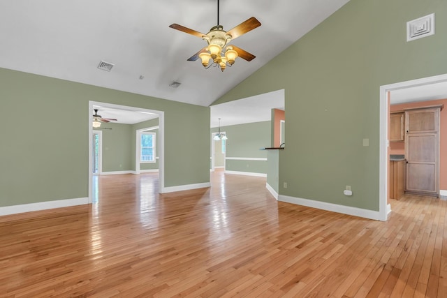 unfurnished living room with baseboards, light wood-style floors, ceiling fan, and high vaulted ceiling