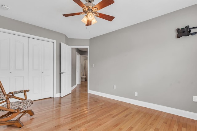 sitting room with baseboards, ceiling fan, and light wood finished floors