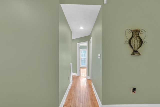 corridor with light wood-style floors and baseboards