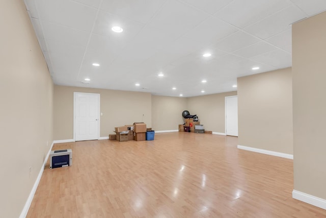 workout room featuring recessed lighting, baseboards, and wood finished floors