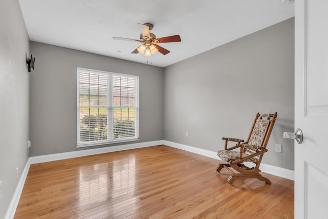 unfurnished room with light wood-style flooring, baseboards, and ceiling fan