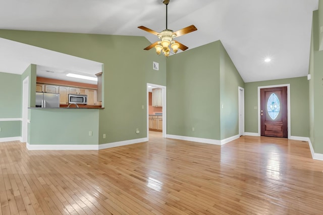 unfurnished living room featuring a ceiling fan, visible vents, baseboards, high vaulted ceiling, and light wood-type flooring