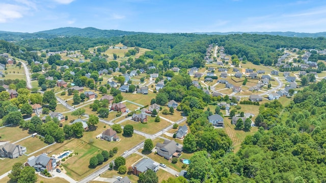 bird's eye view featuring a wooded view and a residential view