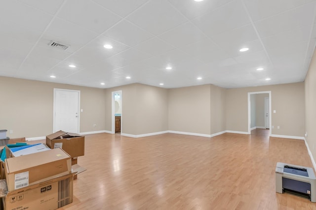 interior space featuring visible vents, light wood-style flooring, and baseboards