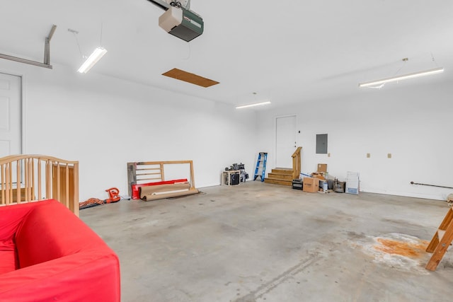 garage with electric panel and a garage door opener