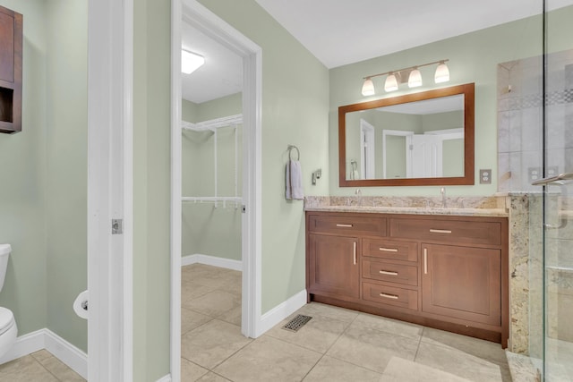 full bath featuring a shower stall, toilet, tile patterned floors, and a sink