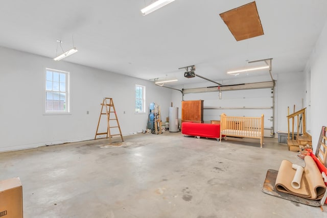 garage featuring water heater and a garage door opener