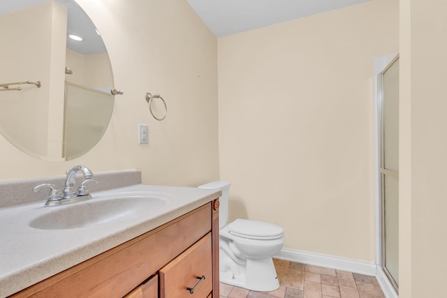 bathroom featuring an enclosed shower, toilet, vanity, and baseboards