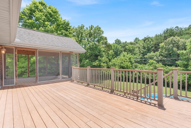 deck with a lawn and a sunroom