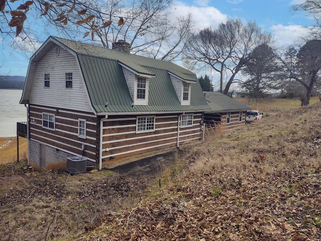 view of side of home featuring a water view and cooling unit