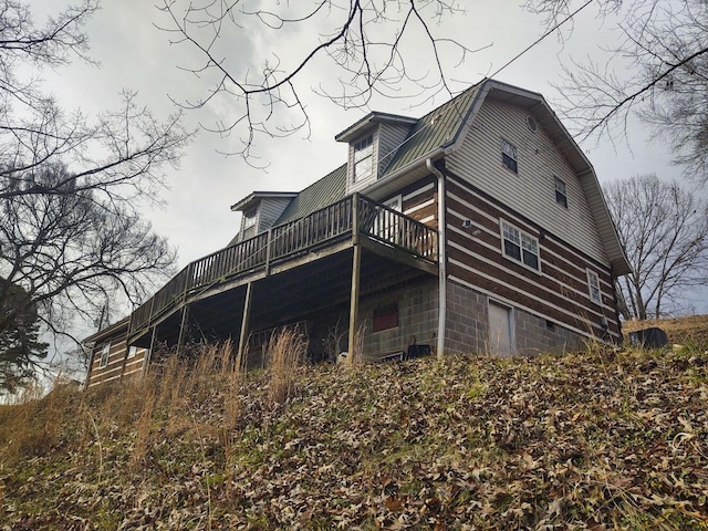 rear view of property featuring a deck