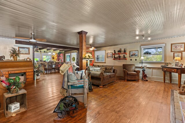 living room with hardwood / wood-style floors, ceiling fan, and decorative columns