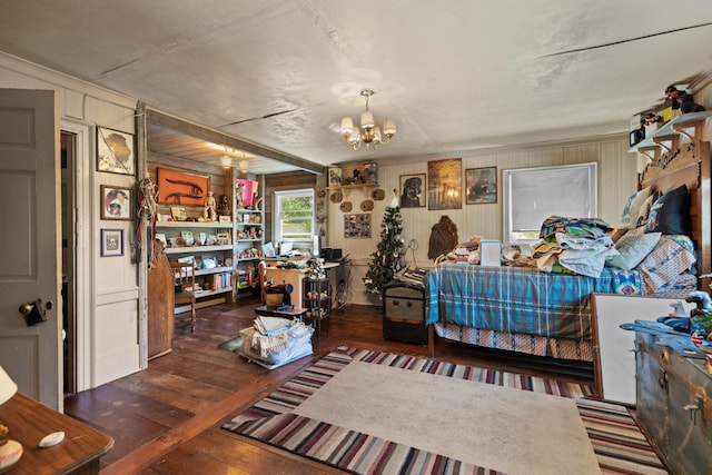 bedroom with a chandelier and dark wood-type flooring