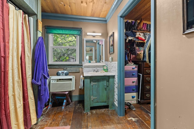 bathroom with hardwood / wood-style floors, vanity, a wall mounted air conditioner, and ornamental molding