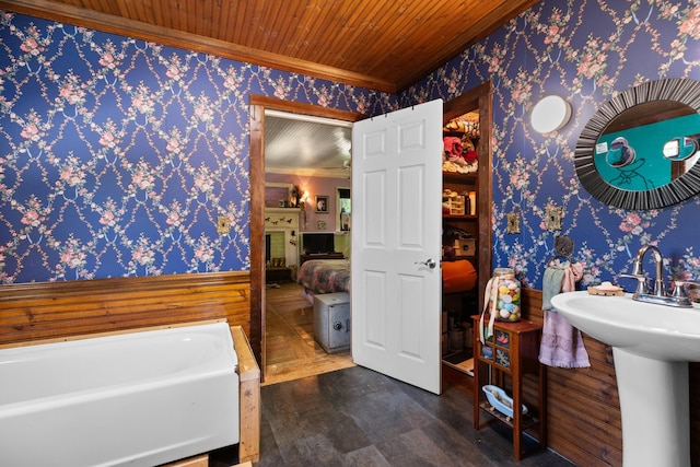 bathroom with a washtub, wood-type flooring, wooden ceiling, and crown molding