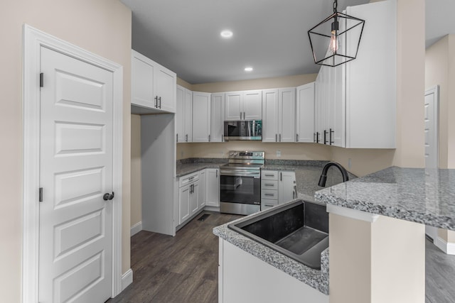 3083 Bridgewater Blvd, Morristown, TN 37814 - kitchen featuring stainless steel appliances, dark wood-type flooring, white cabinets, a peninsula, and light stone countertops