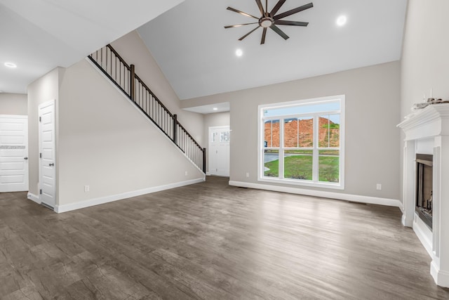 3083 Bridgewater Blvd, Morristown, TN 37814 - unfurnished living room with a fireplace, ceiling fan, high vaulted ceiling, dark wood finished floors, and stairs