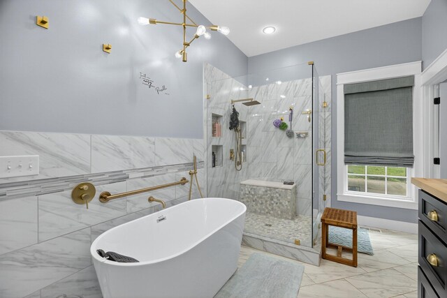 718 Mullins Dr, Sneedville, TN 37869 - full bathroom featuring marble finish flooring, a freestanding tub, a marble finish shower, vanity, and tile walls