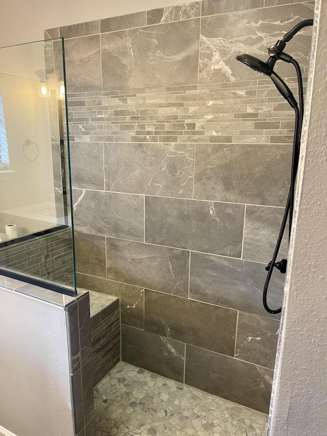 bathroom with a tile shower