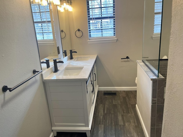 bathroom with a chandelier, hardwood / wood-style floors, and vanity