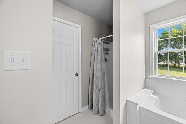 1790 Butterfly Ct, Whitesburg, TN 37891 - bathroom featuring a bath, a shower with shower curtain, tile patterned floors, and baseboards