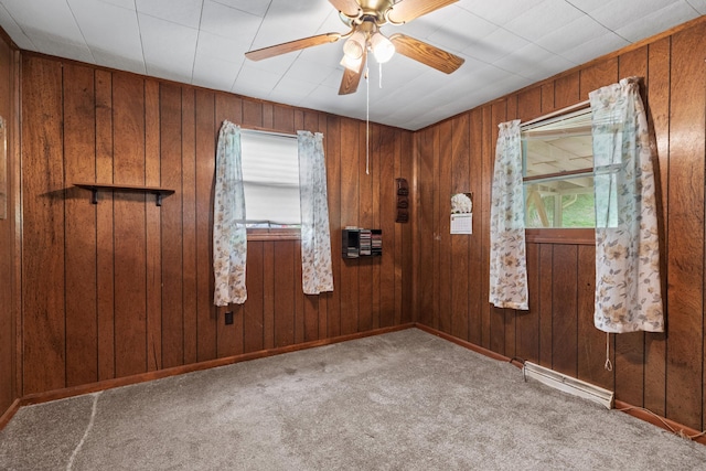 1900 Mountain View Ave, Kingsport, TN 37664 - carpeted empty room featuring a ceiling fan, baseboards, wood walls, and a baseboard radiator