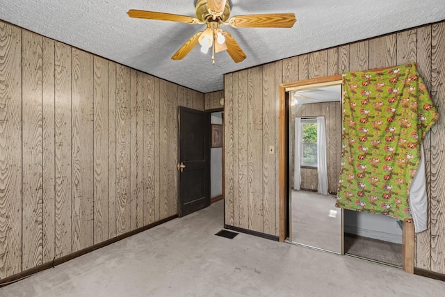 1900 Mountain View Ave, Kingsport, TN 37664 - unfurnished bedroom featuring wooden walls, baseboards, a textured ceiling, and visible vents