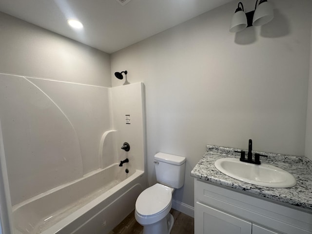 full bathroom with vanity, hardwood / wood-style flooring, toilet, and shower / washtub combination