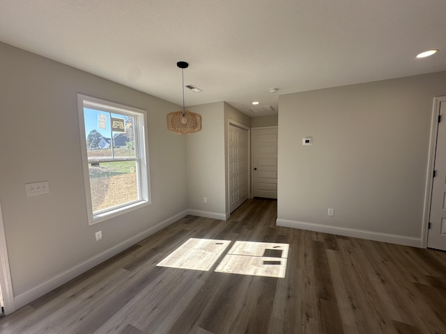 unfurnished dining area featuring dark hardwood / wood-style floors