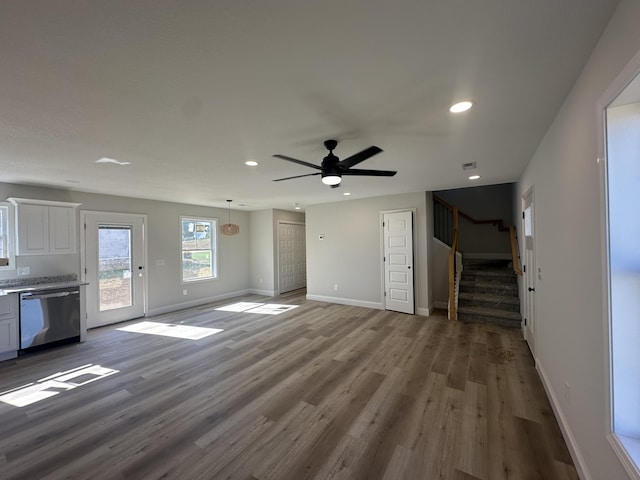 unfurnished living room featuring ceiling fan and wood-type flooring