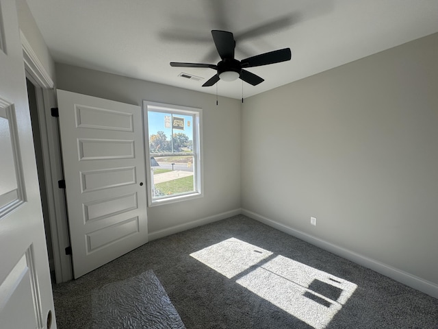 carpeted empty room featuring ceiling fan