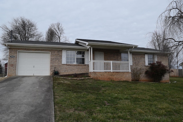 ranch-style house featuring covered porch, a front lawn, driveway, a garage, and brick siding