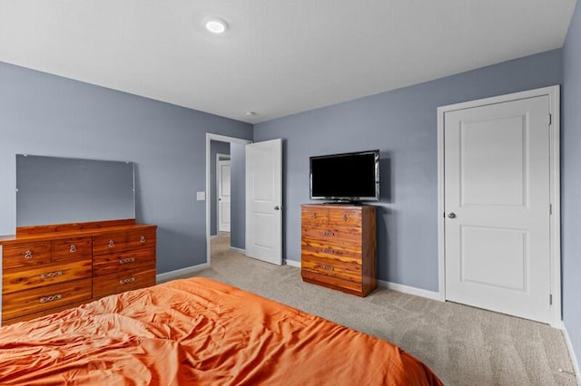 bedroom featuring baseboards and carpet