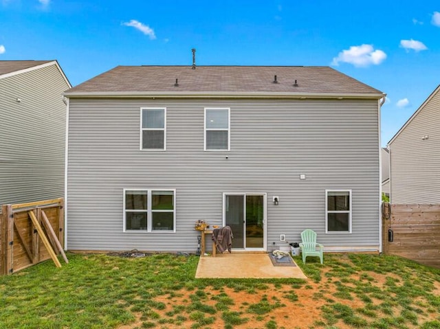 back of house featuring a lawn, a patio, a gate, and a fenced backyard