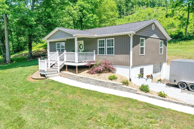 2466 Kidwell Ridge Rd, Morristown, TN 37814 - view of front of home with a porch, a front yard, an attached garage, and a wooded view