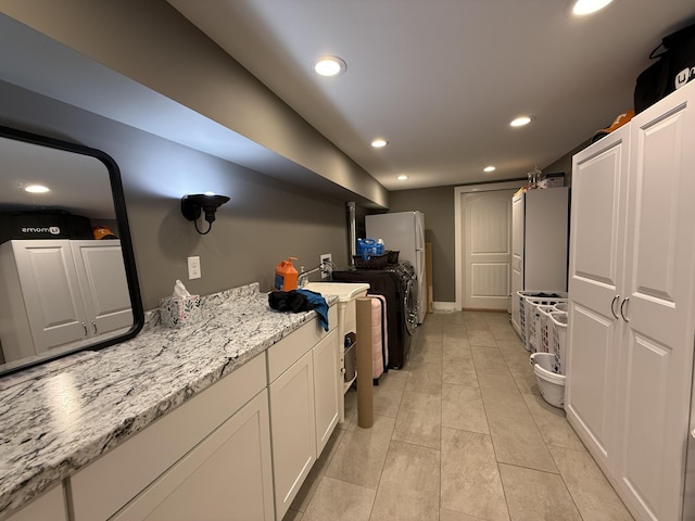 2466 Kidwell Ridge Rd, Morristown, TN 37814 - kitchen with recessed lighting, white cabinetry, independent washer and dryer, light stone counters, and light tile patterned floors