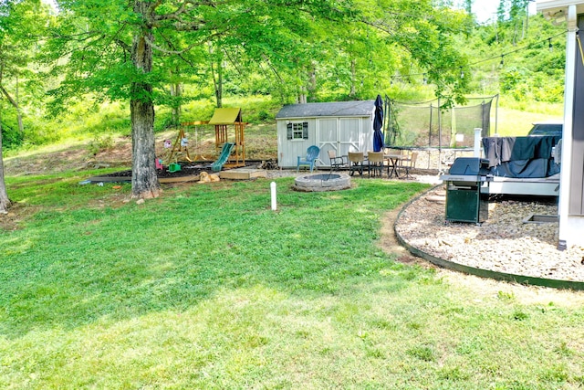 2466 Kidwell Ridge Rd, Morristown, TN 37814 - view of grassy yard with a trampoline, a storage unit, an outbuilding, a playground, and an outdoor fire pit