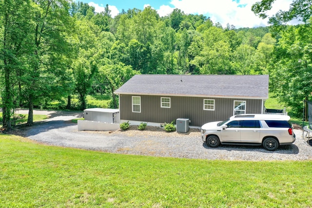2466 Kidwell Ridge Rd, Morristown, TN 37814 - view of home's exterior with central AC unit, a yard, roof with shingles, and a view of trees
