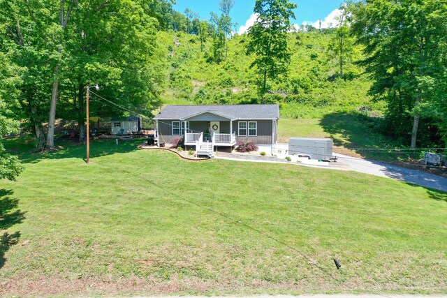 2466 Kidwell Ridge Rd, Morristown, TN 37814 - view of front of property with covered porch, a front lawn, and a wooded view