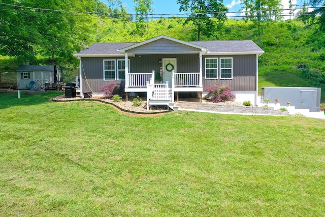 2466 Kidwell Ridge Rd, Morristown, TN 37814 - view of front facade with covered porch, a front yard, and an outbuilding