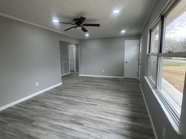 spare room with crown molding, baseboards, recessed lighting, and a ceiling fan