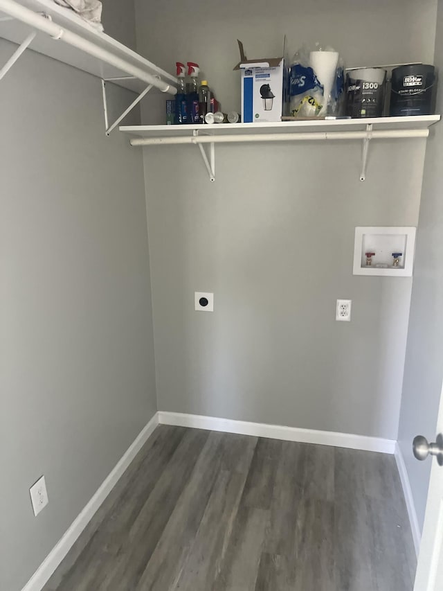clothes washing area featuring electric dryer hookup, wood finished floors, hookup for a washing machine, and baseboards