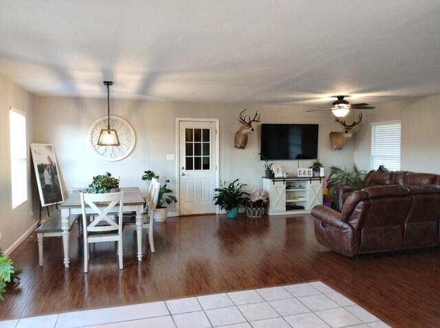 living room featuring ceiling fan and light tile patterned floors