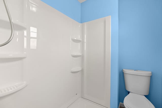 bathroom with walk in shower and toilet