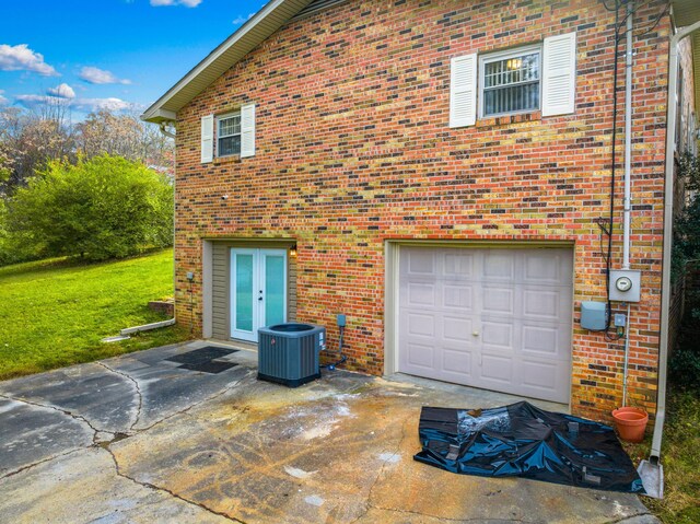 view of property exterior featuring a garage and central AC unit