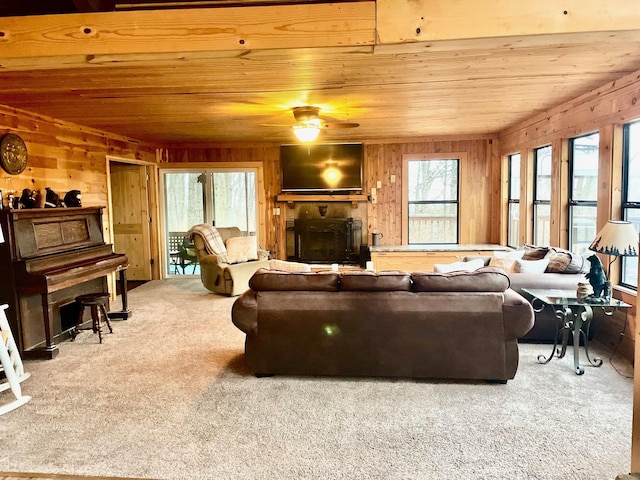 living room with ceiling fan, wood ceiling, and carpet floors