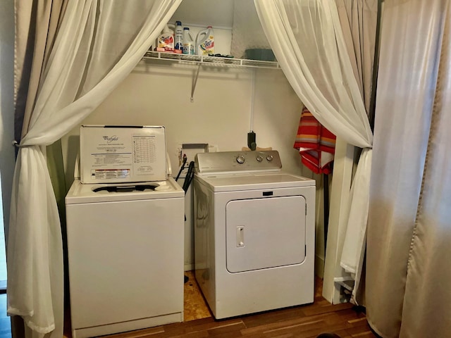 clothes washing area with separate washer and dryer and hardwood / wood-style flooring